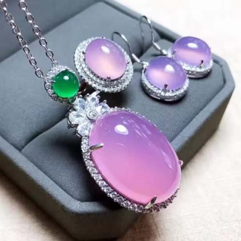Handcrafted inlaid egg face pendant necklace, earring, and ring set featuring violet-pink chalcedony gemstones. A unique boho-chic spiritual jewelry piece with natural crystal healing properties